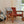 red leather and wood sling chair in living room with a throw blanket sitting next to a guitar